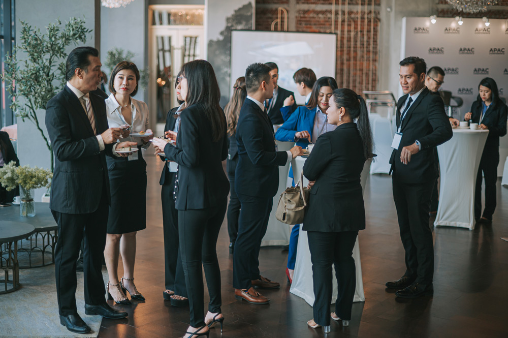 People in business attire mingle at a professional networking event.